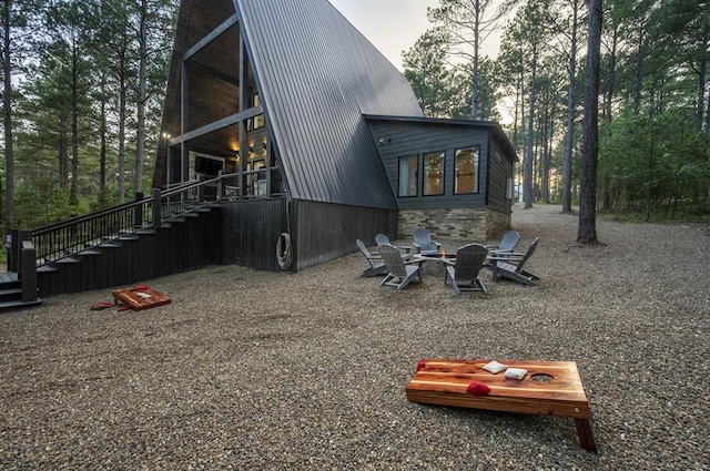 316 Triton Trl, Broken Bow, OK 74728 - rear view of house with stairway, a metal roof, and a fire pit