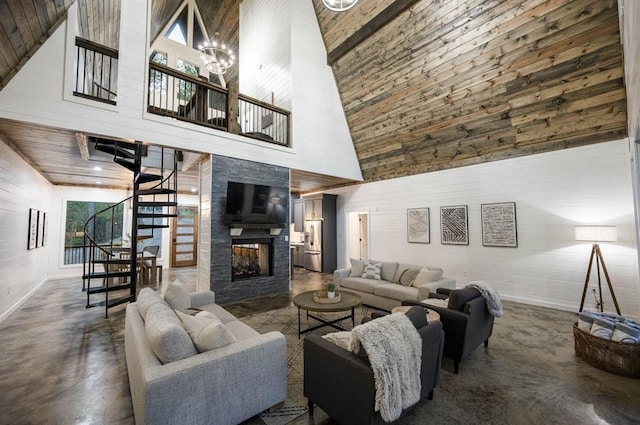 316 Triton Trl, Broken Bow, OK 74728 - living room featuring high vaulted ceiling, stairway, concrete floors, wooden walls, and a multi sided fireplace
