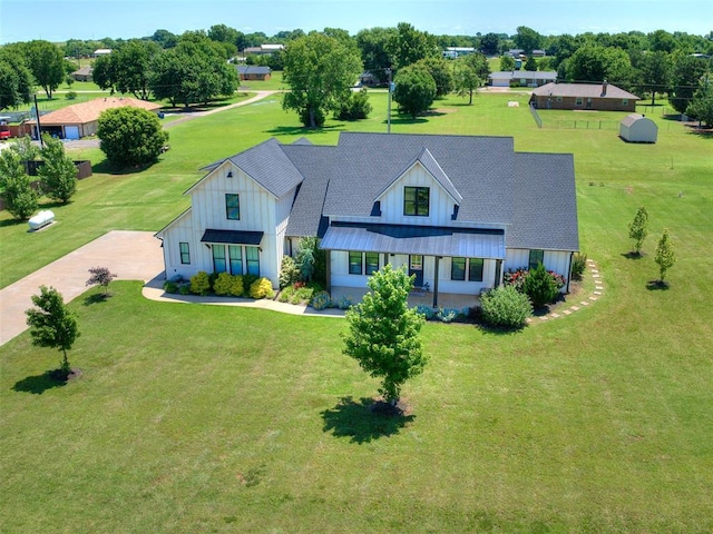 22795 Cterling Dr, Kingfisher, OK 73750 - view of front of house featuring board and batten siding, a front lawn, and roof with shingles