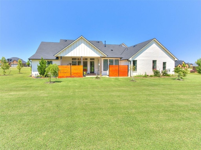 22795 Cterling Dr, Kingfisher, OK 73750 - back of property featuring a lawn and board and batten siding