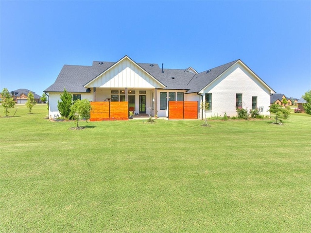 22795 Cterling Dr, Kingfisher, OK 73750 - back of property featuring a lawn and board and batten siding