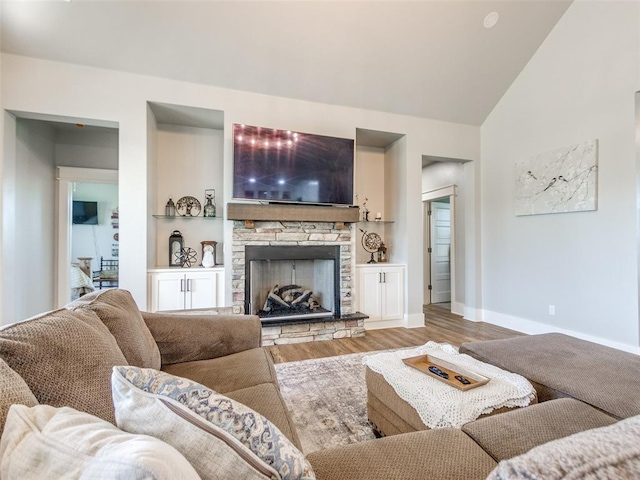 22795 Cterling Dr, Kingfisher, OK 73750 - living area featuring wood finished floors, a fireplace, and lofted ceiling