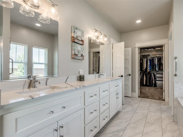 22795 Cterling Dr, Kingfisher, OK 73750 - full bath with marble look tiles, double vanity, recessed lighting, and a walk in closet