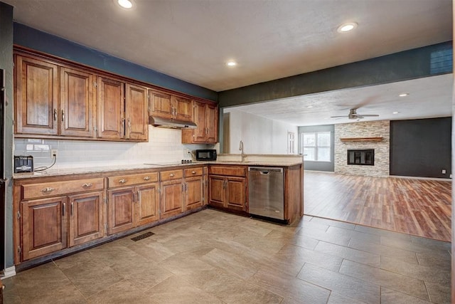 3208 NW 47th St, Oklahoma City, OK 73112 - kitchen with black appliances, under cabinet range hood, a peninsula, a ceiling fan, and brown cabinetry