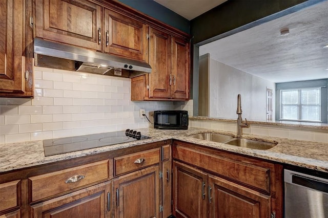 3208 NW 47th St, Oklahoma City, OK 73112 - kitchen with black appliances, under cabinet range hood, decorative backsplash, light stone countertops, and brown cabinets