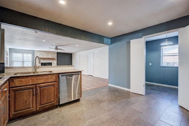 3208 NW 47th St, Oklahoma City, OK 73112 - kitchen featuring dishwasher, a ceiling fan, a fireplace, open floor plan, and light stone countertops