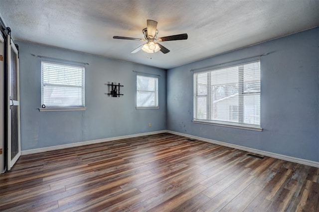3208 NW 47th St, Oklahoma City, OK 73112 - unfurnished room featuring dark wood finished floors and a ceiling fan