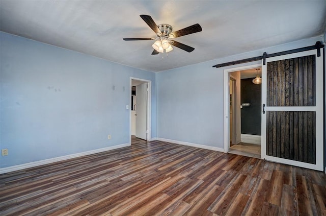 3208 NW 47th St, Oklahoma City, OK 73112 - unfurnished room featuring a ceiling fan, a barn door, and wood finished floors