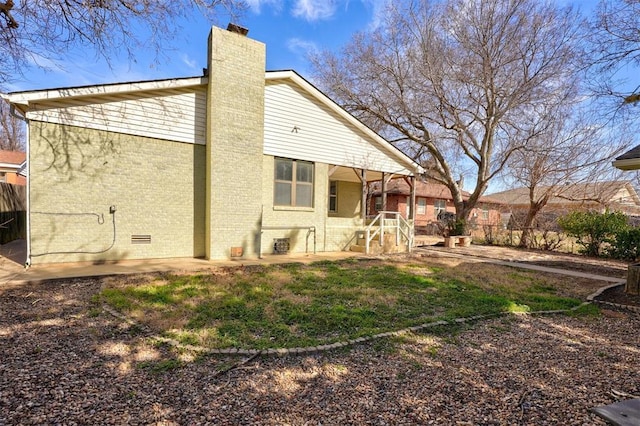3208 NW 47th St, Oklahoma City, OK 73112 - back of property with a chimney, brick siding, and a porch