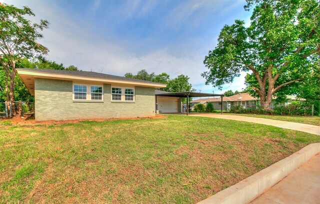 5309 S Blackwelder Ave, Oklahoma City, OK 73119 - ranch-style home featuring brick siding, an attached carport, and driveway