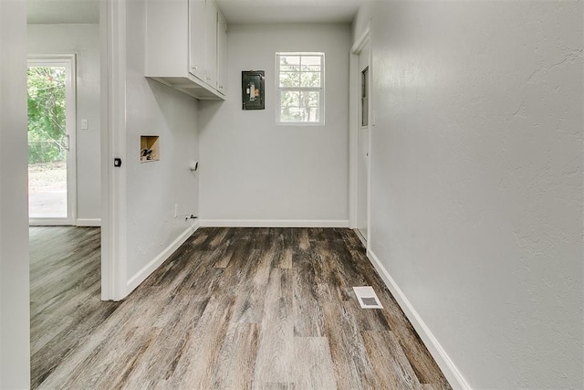 5309 S Blackwelder Ave, Oklahoma City, OK 73119 - laundry room featuring cabinet space, wood finished floors, washer hookup, and electric panel