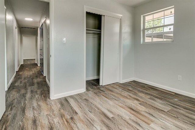 5309 S Blackwelder Ave, Oklahoma City, OK 73119 - unfurnished bedroom with wood finished floors and a closet