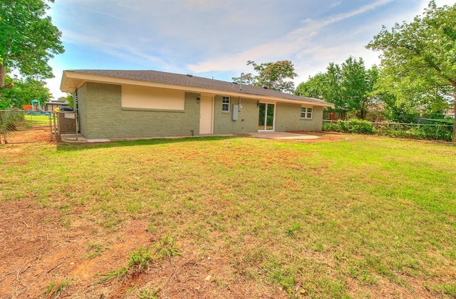 5309 S Blackwelder Ave, Oklahoma City, OK 73119 - back of property with a fenced backyard, a patio area, and brick siding