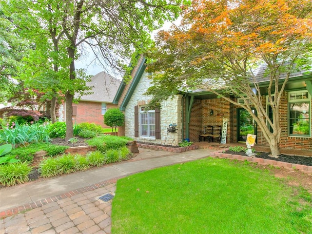4304 Riders Mark, Edmond, OK 73025 - view of front of house with stone siding, brick siding, and a front lawn