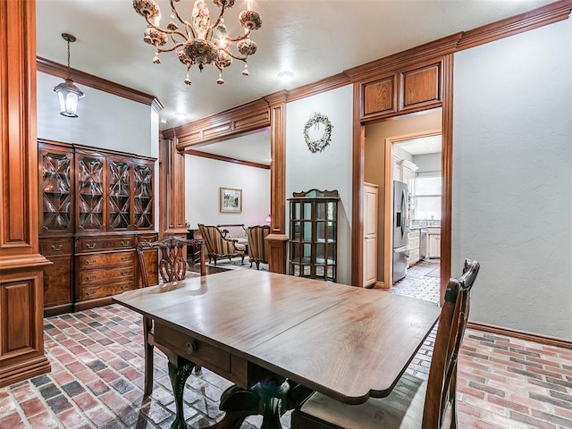 4304 Riders Mark, Edmond, OK 73025 - dining space featuring brick flooring, crown molding, a chandelier, and a textured wall
