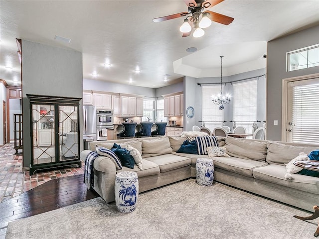 4304 Riders Mark, Edmond, OK 73025 - living area with a chandelier, a ceiling fan, and hardwood / wood-style flooring