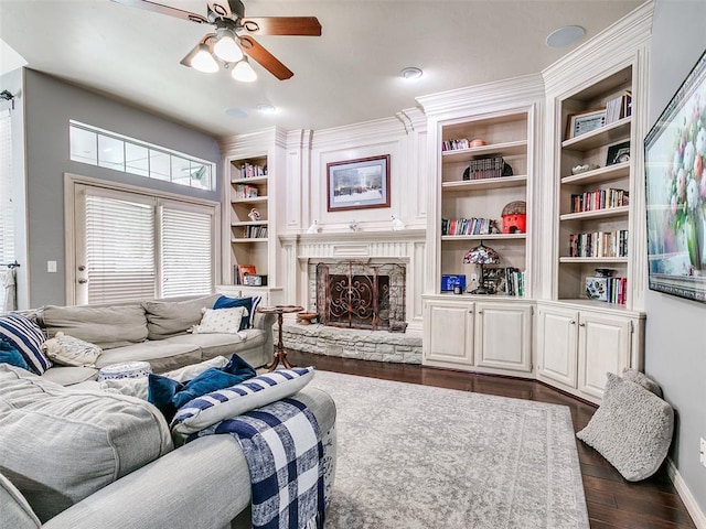 4304 Riders Mark, Edmond, OK 73025 - living room featuring ceiling fan, dark wood-style flooring, a fireplace, and built in features