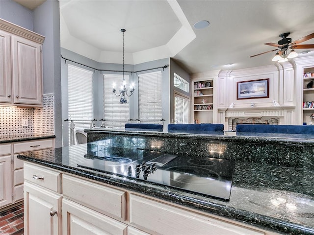 4304 Riders Mark, Edmond, OK 73025 - kitchen with black electric cooktop, a chandelier, a fireplace, ceiling fan, and pendant lighting