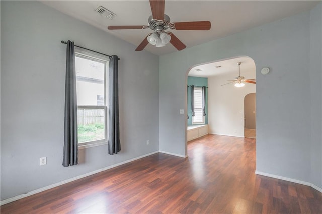 502 S 7th St, Chickasha, OK 73018 - unfurnished room with arched walkways, ceiling fan, and plenty of natural light