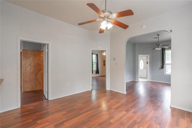 502 S 7th St, Chickasha, OK 73018 - unfurnished room with ceiling fan, healthy amount of natural light, arched walkways, and wood finished floors