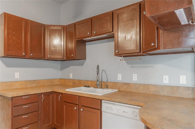 502 S 7th St, Chickasha, OK 73018 - kitchen featuring white dishwasher, light countertops, brown cabinetry, and ventilation hood