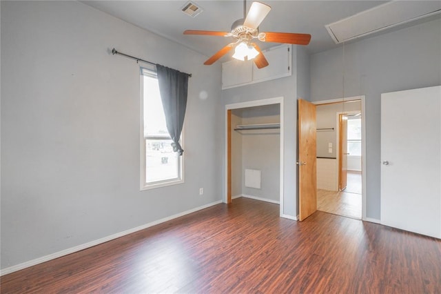 502 S 7th St, Chickasha, OK 73018 - unfurnished bedroom featuring attic access, multiple windows, wood finished floors, and a closet