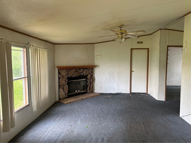 1194 County Street 2955 St, Tuttle, OK 73089 - unfurnished living room with carpet floors, a ceiling fan, a stone fireplace, and crown molding