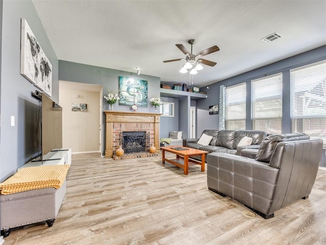 517 Firefork Ave, Yukon, OK 73099 - living area with light wood-type flooring, ceiling fan, and a brick fireplace
