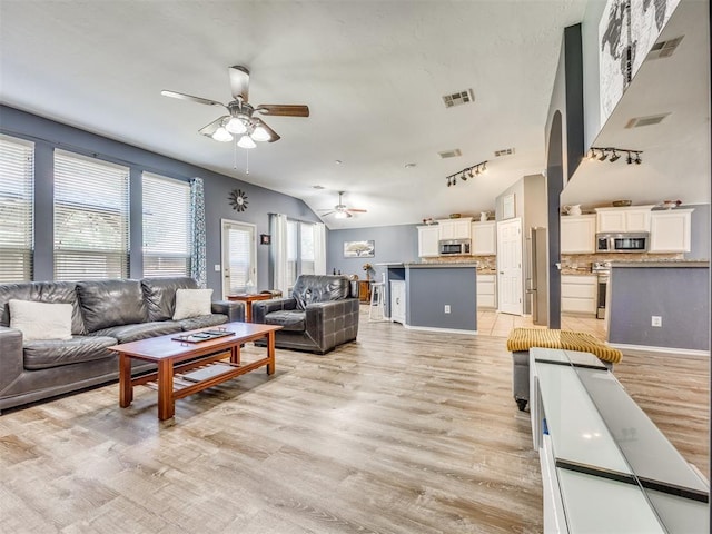 517 Firefork Ave, Yukon, OK 73099 - living area featuring a ceiling fan, light wood-style floors, and vaulted ceiling