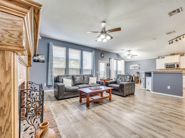 517 Firefork Ave, Yukon, OK 73099 - living room with ceiling fan, light wood finished floors, and a brick fireplace