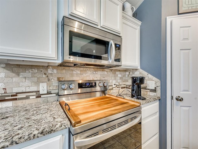 517 Firefork Ave, Yukon, OK 73099 - kitchen with stainless steel appliances, white cabinets, backsplash, and light stone countertops