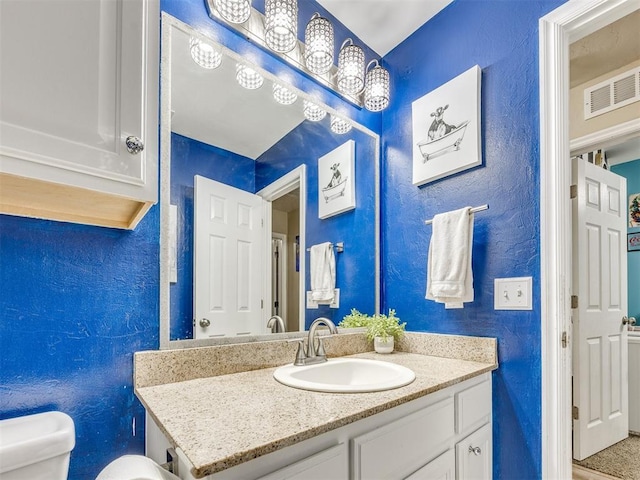 517 Firefork Ave, Yukon, OK 73099 - bathroom featuring a textured wall and vanity