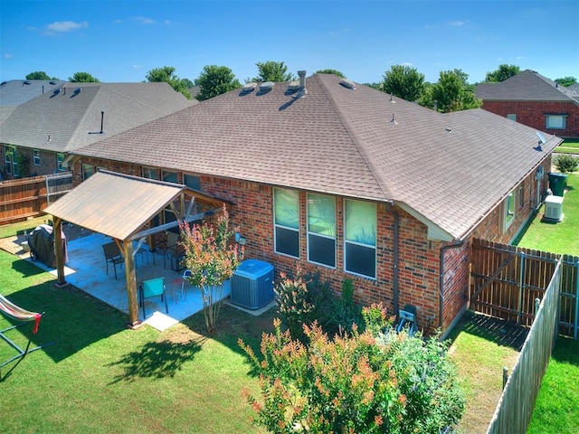 517 Firefork Ave, Yukon, OK 73099 - back of property with brick siding, a shingled roof, a patio area, and a fenced backyard
