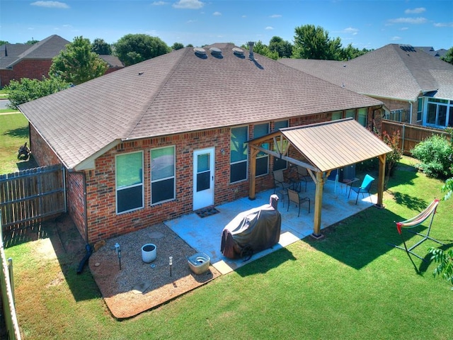 517 Firefork Ave, Yukon, OK 73099 - back of property featuring brick siding, a fenced backyard, a patio, and a shingled roof