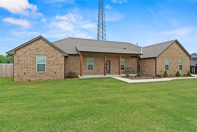 1031 Colonial Ave, Tuttle, OK 73089 - ranch-style home with brick siding, a patio area, and roof with shingles