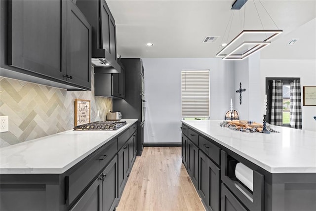 1031 Colonial Ave, Tuttle, OK 73089 - kitchen with stainless steel gas cooktop, wall oven, light wood-type flooring, recessed lighting, and decorative backsplash