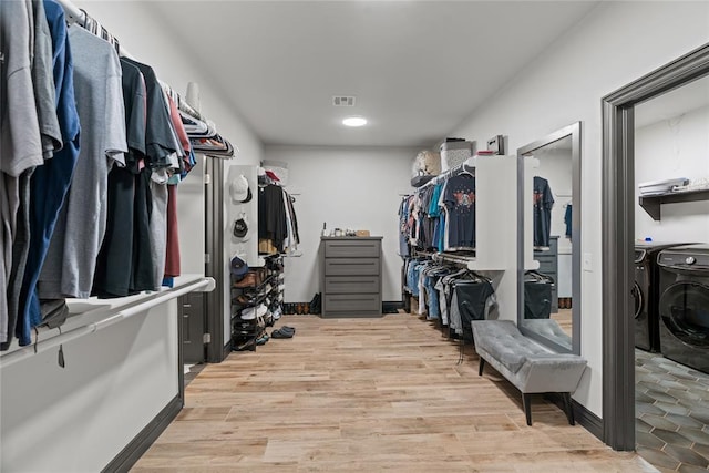 1031 Colonial Ave, Tuttle, OK 73089 - walk in closet with washer and clothes dryer and wood finished floors