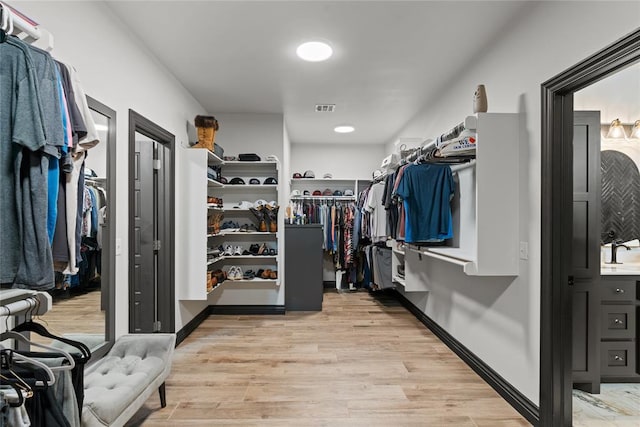 1031 Colonial Ave, Tuttle, OK 73089 - spacious closet with light wood-style flooring and a sink