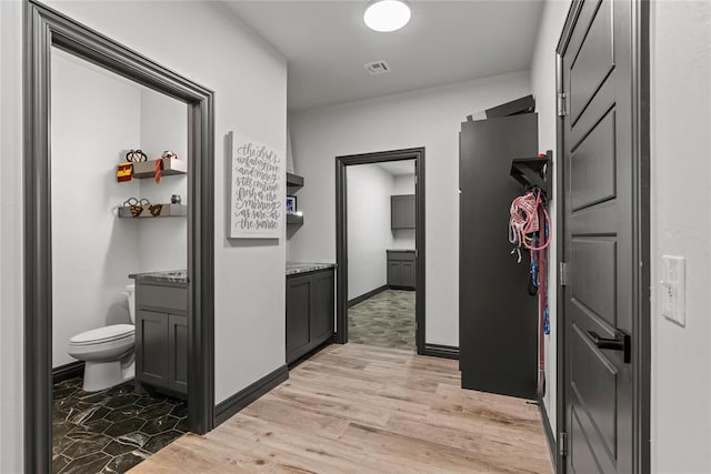 1031 Colonial Ave, Tuttle, OK 73089 - corridor featuring light wood finished floors and baseboards