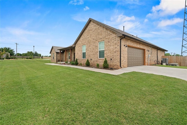 1031 Colonial Ave, Tuttle, OK 73089 - view of home's exterior with brick siding, concrete driveway, and a garage