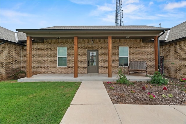 1031 Colonial Ave, Tuttle, OK 73089 - property entrance with brick siding, a patio area, and a yard