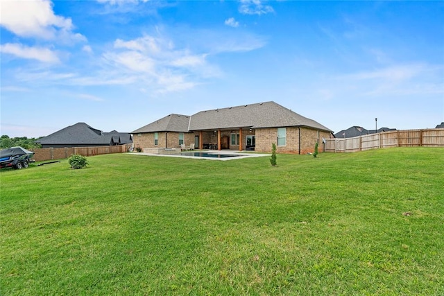 1031 Colonial Ave, Tuttle, OK 73089 - back of house with a fenced backyard, a patio, and brick siding