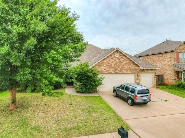 2909 Marigold Ln, Edmond, OK 73013 - view of front facade featuring concrete driveway, brick siding, a garage, and a front lawn