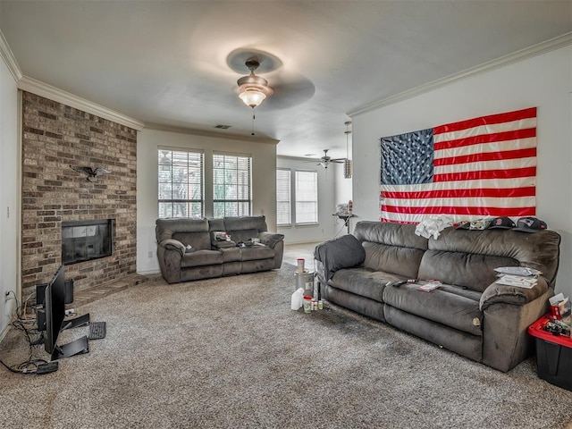 2909 Marigold Ln, Edmond, OK 73013 - carpeted living area featuring ceiling fan, crown molding, and a brick fireplace