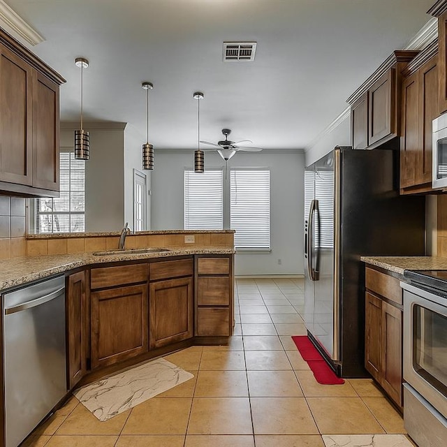 2909 Marigold Ln, Edmond, OK 73013 - kitchen with appliances with stainless steel finishes, hanging light fixtures, ceiling fan, and light tile patterned floors