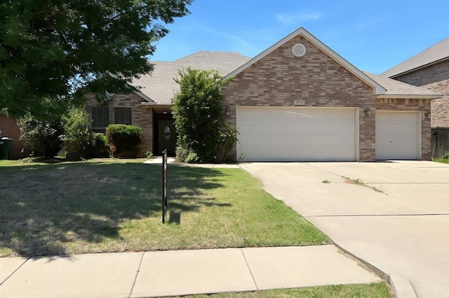 2909 Marigold Ln, Edmond, OK 73013 - ranch-style house featuring a garage, brick siding, concrete driveway, and a front lawn