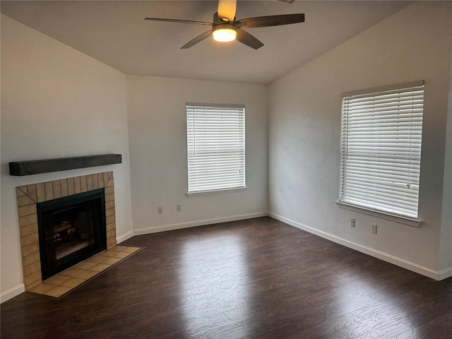 3000 Chautauqua Ave Unit 208, Norman, OK 73072 - unfurnished living room featuring a ceiling fan, wood finished floors, a tiled fireplace, and lofted ceiling