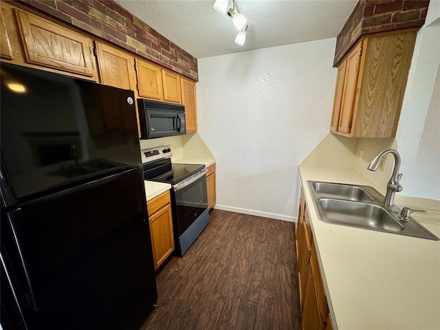 3000 Chautauqua Ave Unit 208, Norman, OK 73072 - kitchen featuring black appliances, dark wood finished floors, a textured ceiling, light countertops, and brown cabinets