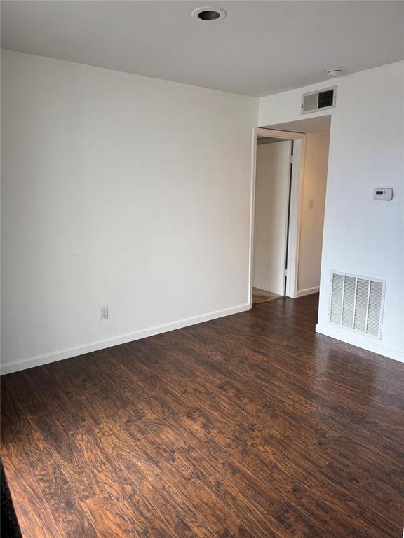 3000 Chautauqua Ave Unit 208, Norman, OK 73072 - empty room with wood finished floors and baseboards