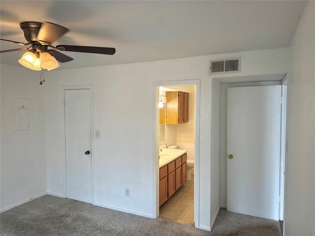 3000 Chautauqua Ave Unit 208, Norman, OK 73072 - unfurnished bedroom with electric panel, light carpet, connected bathroom, and ceiling fan